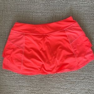 Bright orange Athleta tennis skirt